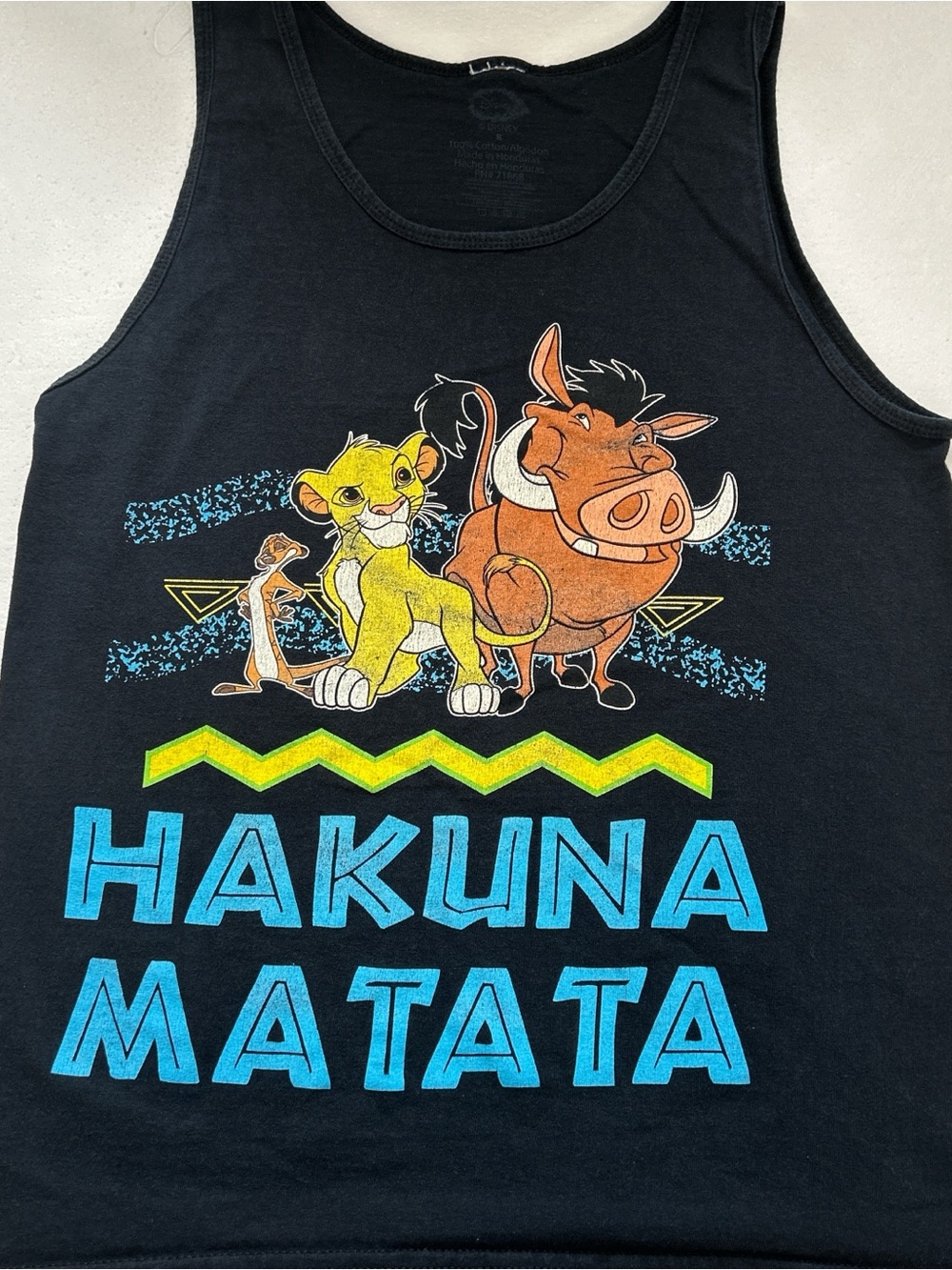 Disney The Lion King "Hakuna Matata" graphic tank top.The design showcases a cl